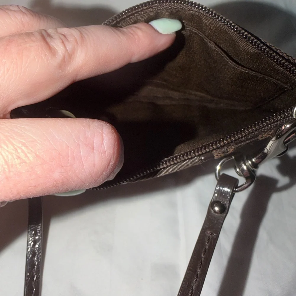 Coach Signature C canvas wristlet.